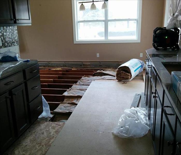 Exposed floor joists in a home during mold mitigation.