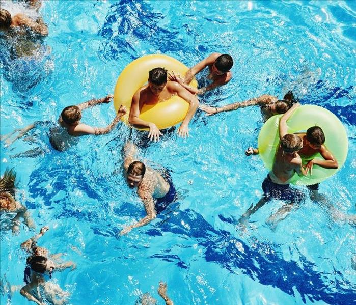 a group of people swimming in pool